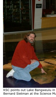 Kevin Cummings points out Lake Bangweulu in Zambia to Bob Bulter and Bernard Sietman at the Science Museum of Minnesota, St. Paul.