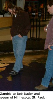 Kevin Cummings points out Lake Bangweulu in Zambia to Bob Bulter and Bernard Sietman at the Science Museum of Minnesota, St. Paul.