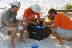 Jeremy Tiemann, Curt Elderkin, and Anthony Geneva biopse tissue samples for DNA analysis