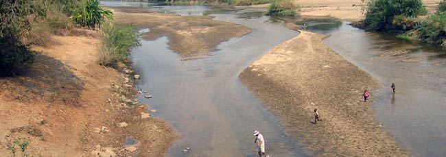 Anthony Geneva, with his local assistants in tow, in the Siamombo River.